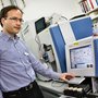 Associate Professor Johan Palmfeldt beside the new mass spectrometer, which is used for advanced protein analysis (Photo: Tonny Foghmar, Aarhus University Hospital).