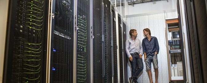 The Genome DK HPC HUB supercomputer at Aarhus University was used for a considerable part of the data processing in connection with mapping the Danish genome. Professor Anders Børglum, Department of Biomedicine (right), is seen here with Professor Mikkel Heide Schierup, Bioinformatics Research Centre (BiRC). Photo: Aarhus University